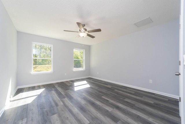 spare room with a textured ceiling, dark hardwood / wood-style floors, and ceiling fan