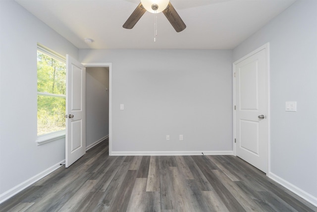 unfurnished room with ceiling fan and dark hardwood / wood-style flooring