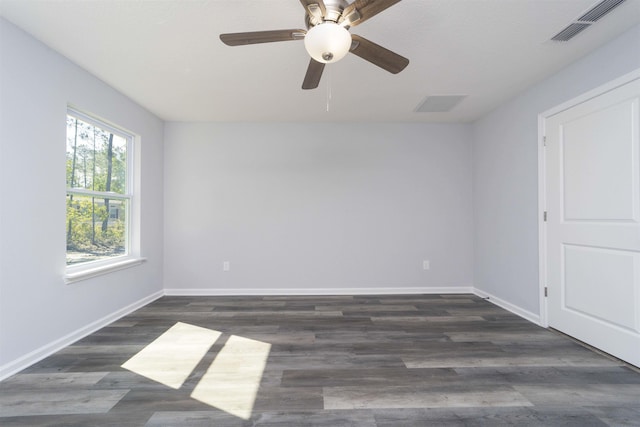 spare room with ceiling fan and dark wood-type flooring