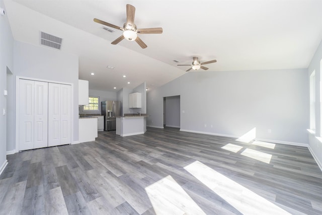 unfurnished living room with ceiling fan, dark hardwood / wood-style floors, and lofted ceiling