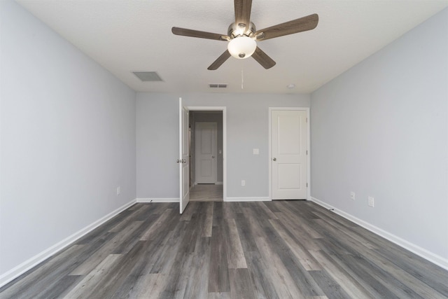 unfurnished bedroom with a textured ceiling, dark hardwood / wood-style flooring, and ceiling fan