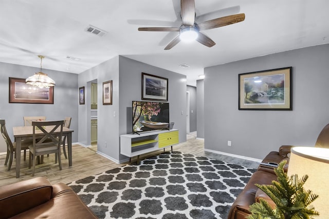 101 Vista Lagoon Ct Unit A-4, Ponte Vedra Beach, FL 32082 - living room featuring light wood-type flooring, baseboards, a ceiling fan, and a chandelier