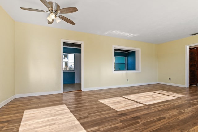 spare room with hardwood / wood-style floors and ceiling fan