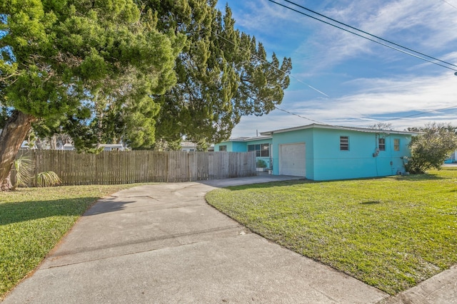 view of side of home with a yard and a garage