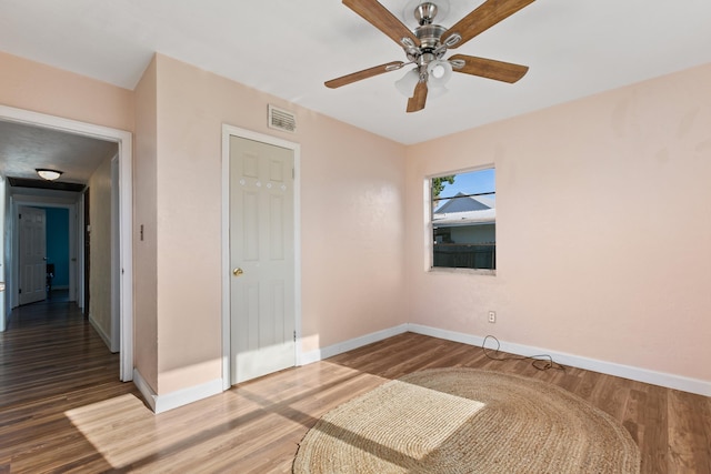 unfurnished bedroom featuring hardwood / wood-style flooring and ceiling fan