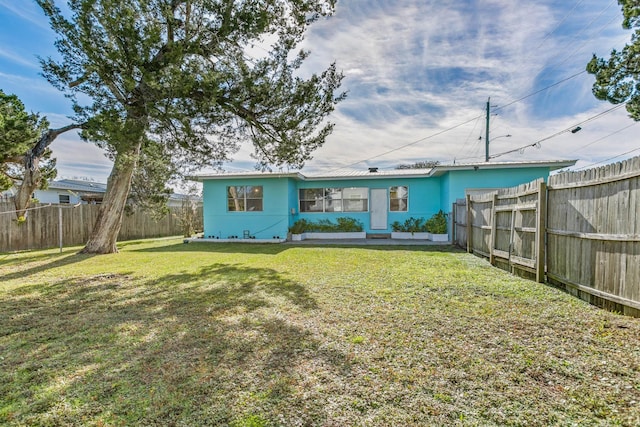 back of house featuring a lawn