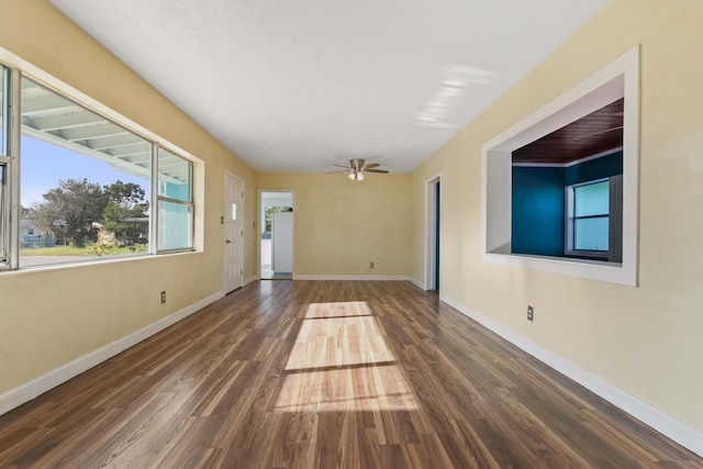 spare room featuring ceiling fan and dark hardwood / wood-style floors