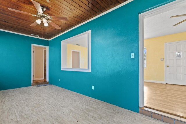 empty room with hardwood / wood-style floors, crown molding, ceiling fan, and wooden ceiling