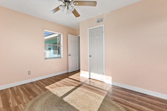 interior space with hardwood / wood-style floors, ceiling fan, and a closet