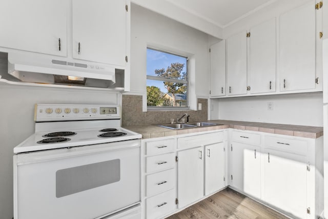 kitchen featuring white range with electric cooktop, tile counters, white cabinets, and sink