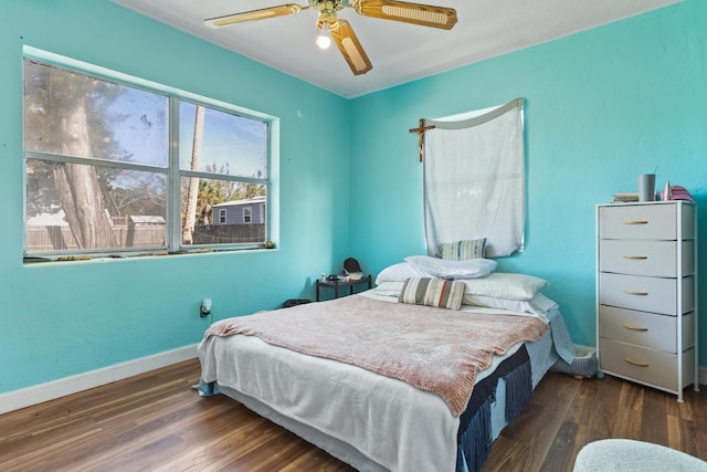 bedroom featuring ceiling fan and dark hardwood / wood-style flooring