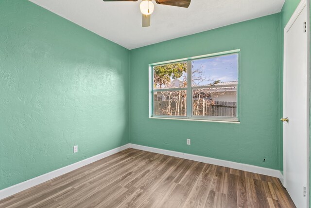 spare room featuring hardwood / wood-style floors and ceiling fan