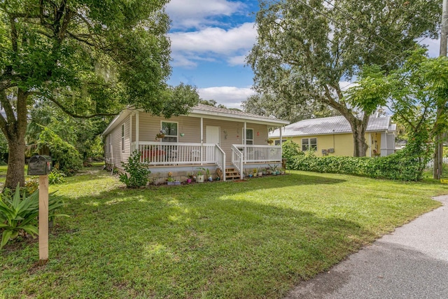 ranch-style house with a front lawn and a porch