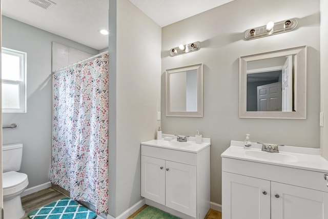 bathroom with curtained shower, hardwood / wood-style floors, a textured ceiling, toilet, and vanity