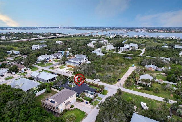 drone / aerial view with a water view and a residential view