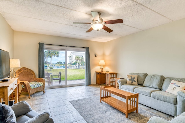 tiled living room with ceiling fan