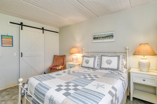 tiled bedroom featuring a barn door