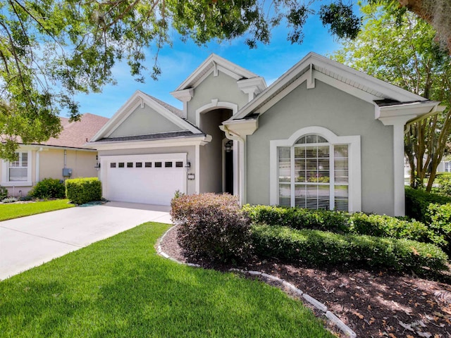 ranch-style house with a garage and a front yard