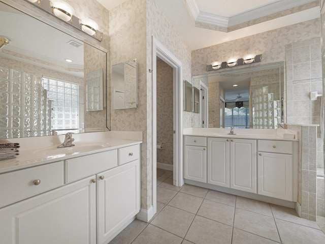 bathroom with crown molding, tile patterned flooring, and vanity