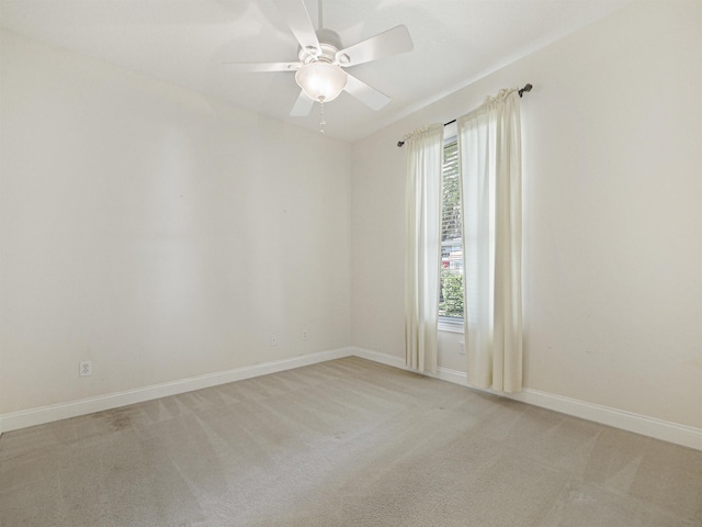 spare room featuring plenty of natural light, ceiling fan, and light colored carpet