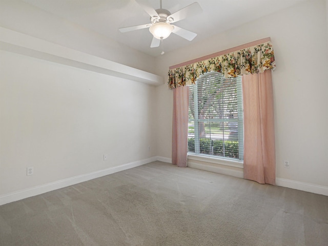 spare room featuring carpet flooring and ceiling fan