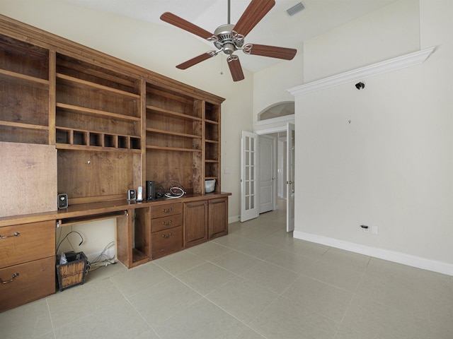 unfurnished office featuring french doors, vaulted ceiling, ceiling fan, and light tile patterned flooring