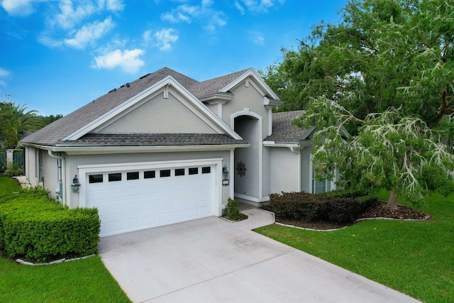 view of front of house with a front lawn and a garage