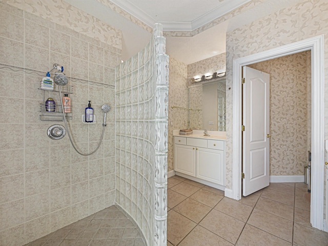 bathroom with tile patterned floors, vanity, a tile shower, and ornamental molding