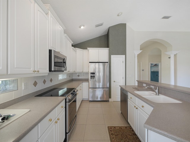 kitchen with white cabinets, light tile patterned floors, and stainless steel appliances