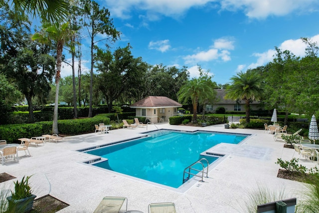 view of pool featuring an outdoor structure and a patio