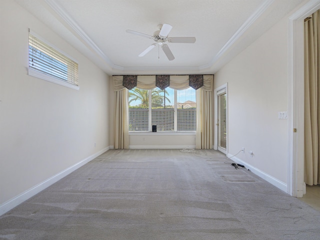 carpeted spare room featuring ceiling fan and crown molding