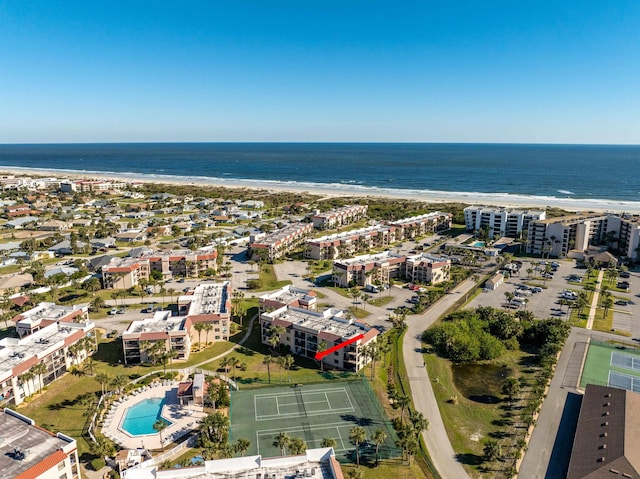 birds eye view of property with a water view and a view of the beach