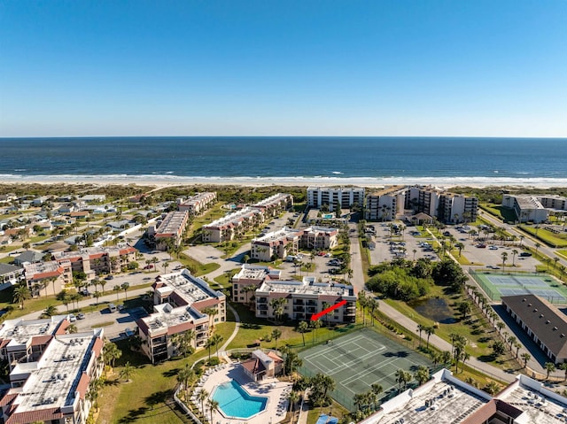 birds eye view of property with a water view and a view of the beach