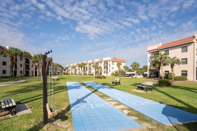 view of home's community featuring a lawn