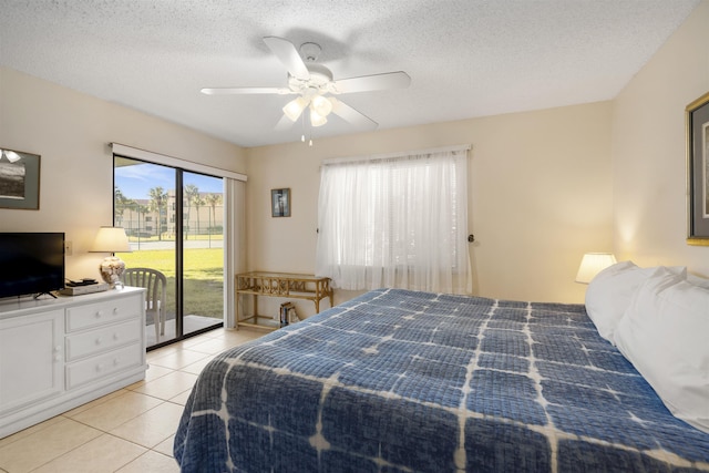 tiled bedroom with access to exterior, ceiling fan, and a textured ceiling