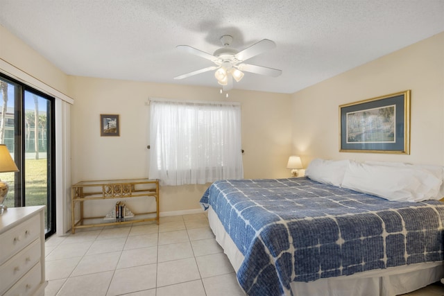 tiled bedroom with a textured ceiling and ceiling fan