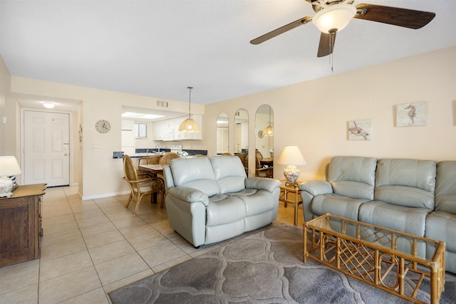 tiled living room featuring ceiling fan