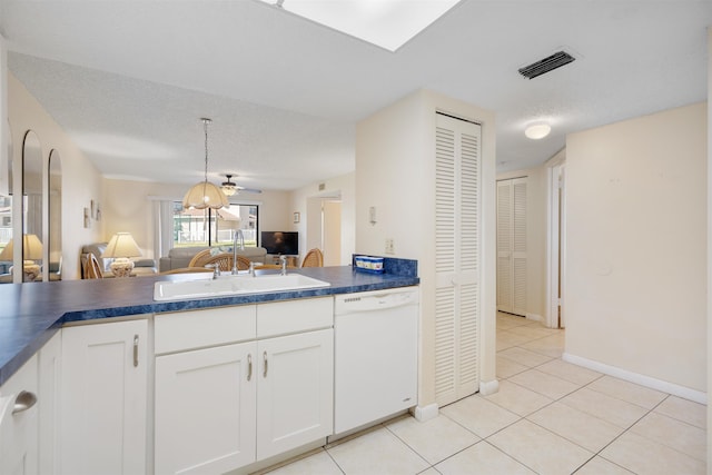 kitchen featuring dishwasher, white cabinets, sink, ceiling fan, and a textured ceiling