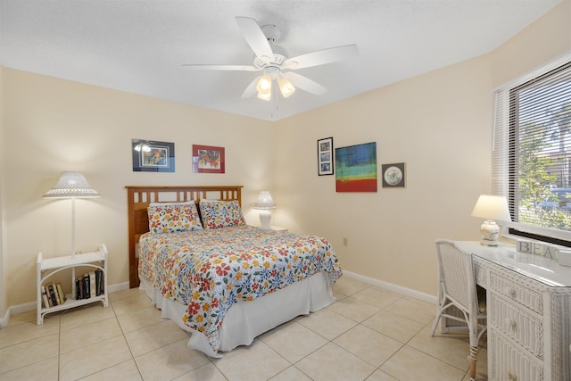 tiled bedroom featuring ceiling fan