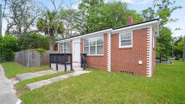 819 Mcduff Ave, Jacksonville, FL 32205 - view of front of home with a deck, a front yard, fence, and brick siding