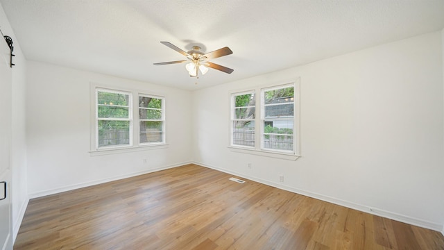 819 Mcduff Ave, Jacksonville, FL 32205 - unfurnished room featuring light wood-type flooring, ceiling fan, baseboards, and visible vents