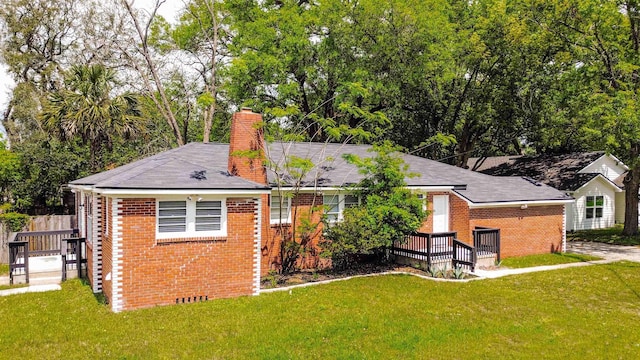 819 Mcduff Ave, Jacksonville, FL 32205 - back of property with brick siding, a yard, and a chimney