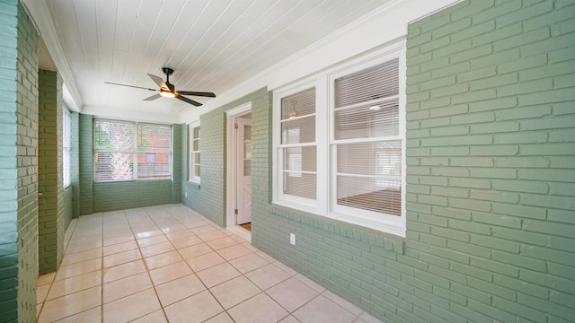 819 Mcduff Ave, Jacksonville, FL 32205 - unfurnished sunroom featuring brick wall, tile patterned floors, and a ceiling fan