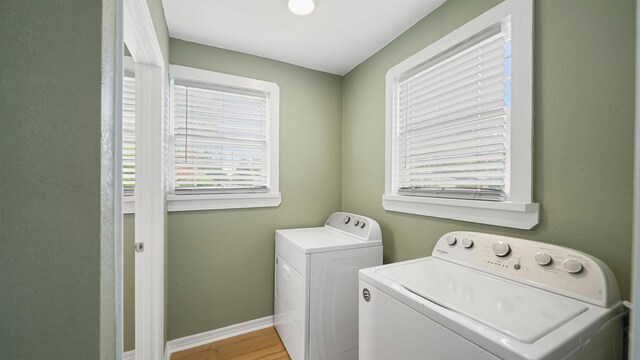 819 Mcduff Ave, Jacksonville, FL 32205 - clothes washing area featuring washer and dryer, laundry area, a healthy amount of sunlight, and baseboards