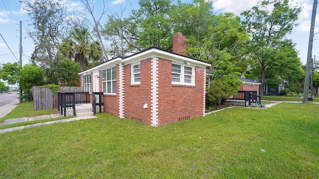 819 Mcduff Ave, Jacksonville, FL 32205 - view of home's exterior featuring a chimney, a yard, and brick siding