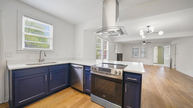 819 Mcduff Ave, Jacksonville, FL 32205 - kitchen featuring stainless steel appliances, blue cabinets, island exhaust hood, and a peninsula