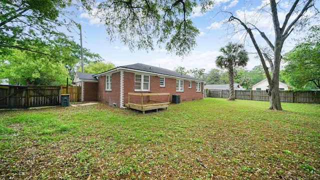 819 Mcduff Ave, Jacksonville, FL 32205 - back of house featuring central AC, a yard, a fenced backyard, and brick siding