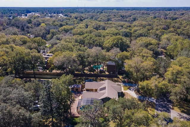 bird's eye view with a wooded view