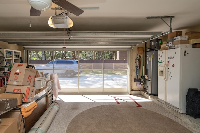 garage featuring a garage door opener, white refrigerator with ice dispenser, and water heater