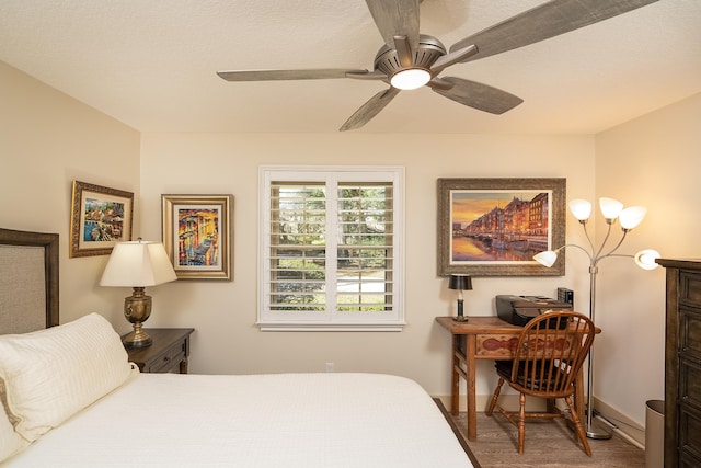 bedroom featuring ceiling fan and baseboards